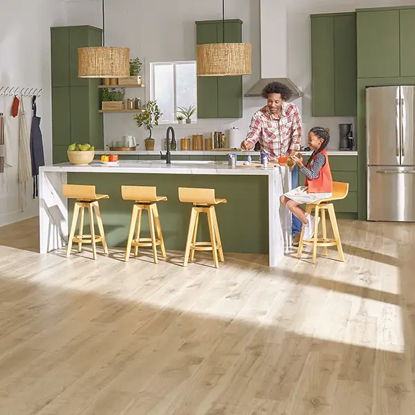 Man and child in green kitchen with new hardwood flooring | DeGraaf Interiors